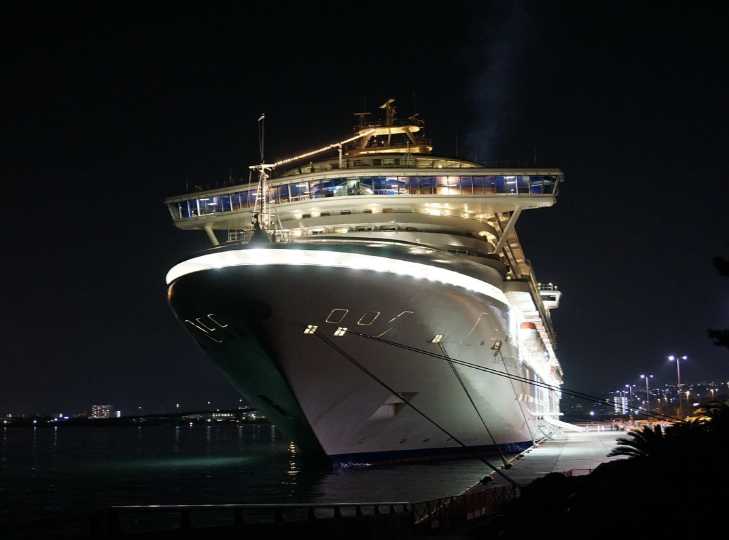 A beautiful night view of a cruise ship in the water, part of the toy airplane and ship collection.