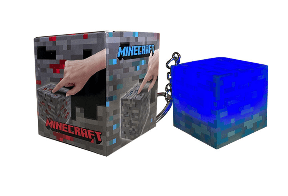 Minecraft torch keychain in bluelight design next to packaging, perfect for fans and collectors.