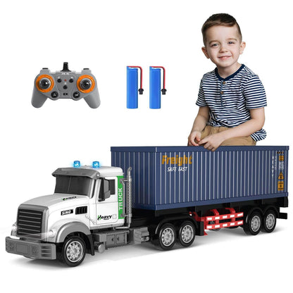Remote control semi truck for kids with trailer, controller, and batteries, featuring a child playing with it.