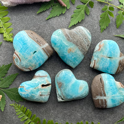 A natural, random Caribbean heart-shaped stone is suitable as a crystal collectible gift.