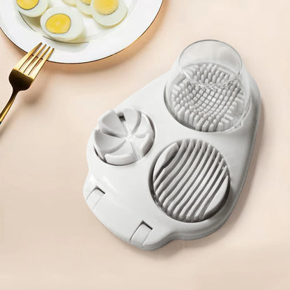 3-in-1 egg cutting tool on a kitchen counter, showcasing its slicer, cracker, and cutter functionalities.