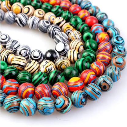 Colorful smooth round beads of various patterns and colors for jewelry making.