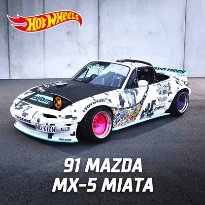 Mazda MX-5 Miata diecast model car in striking racing design with vibrant pink wheels and detailed stickers.