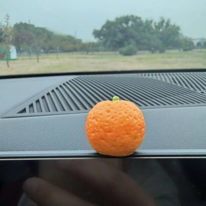 Personalized and creative cartoon car decorations on the center console, simulating orange and lychee car decorations