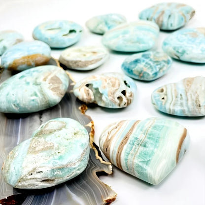 A natural, random Caribbean heart-shaped stone is suitable as a crystal collectible gift.