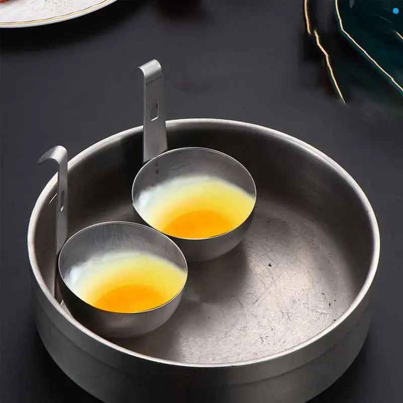 Stainless steel egg poacher with two bowls for efficient egg poaching in the kitchen.