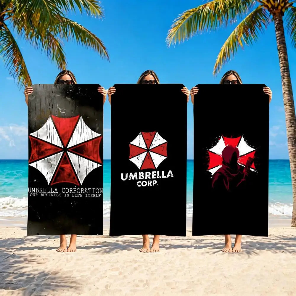Quick dry beach towel for travel displayed on the beach with model holding Umbrella Corporation designs.