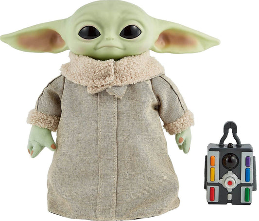 remote control Grogu plush toy with a soft body and sounds, wearing a cozy outfit next to a remote.