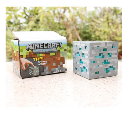 Minecraft color changing sword pickaxe lamp next to light-up diamond ore toy box.