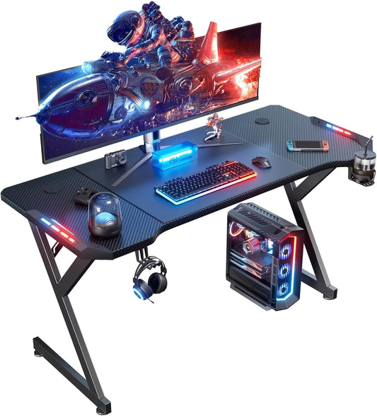 55 Inch Gaming Desk with LED Lights Ergonomic Computer Gaming Table with Carbon Fibre Surface Sturdy PC Workstation Desk for Gaming and Home Office with Headphone Hook Cup Holder Black